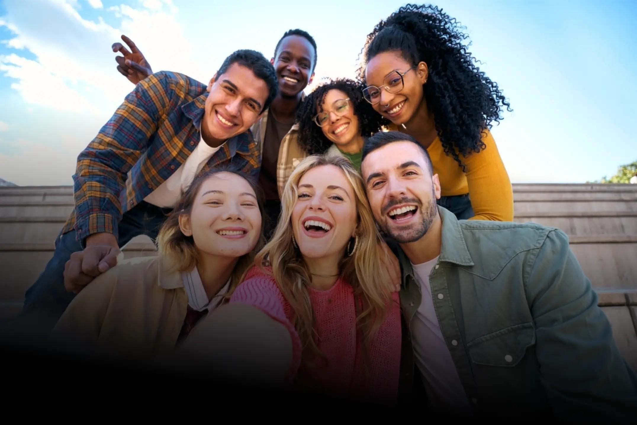 Group of diverse young adults smiling and looking at the camera